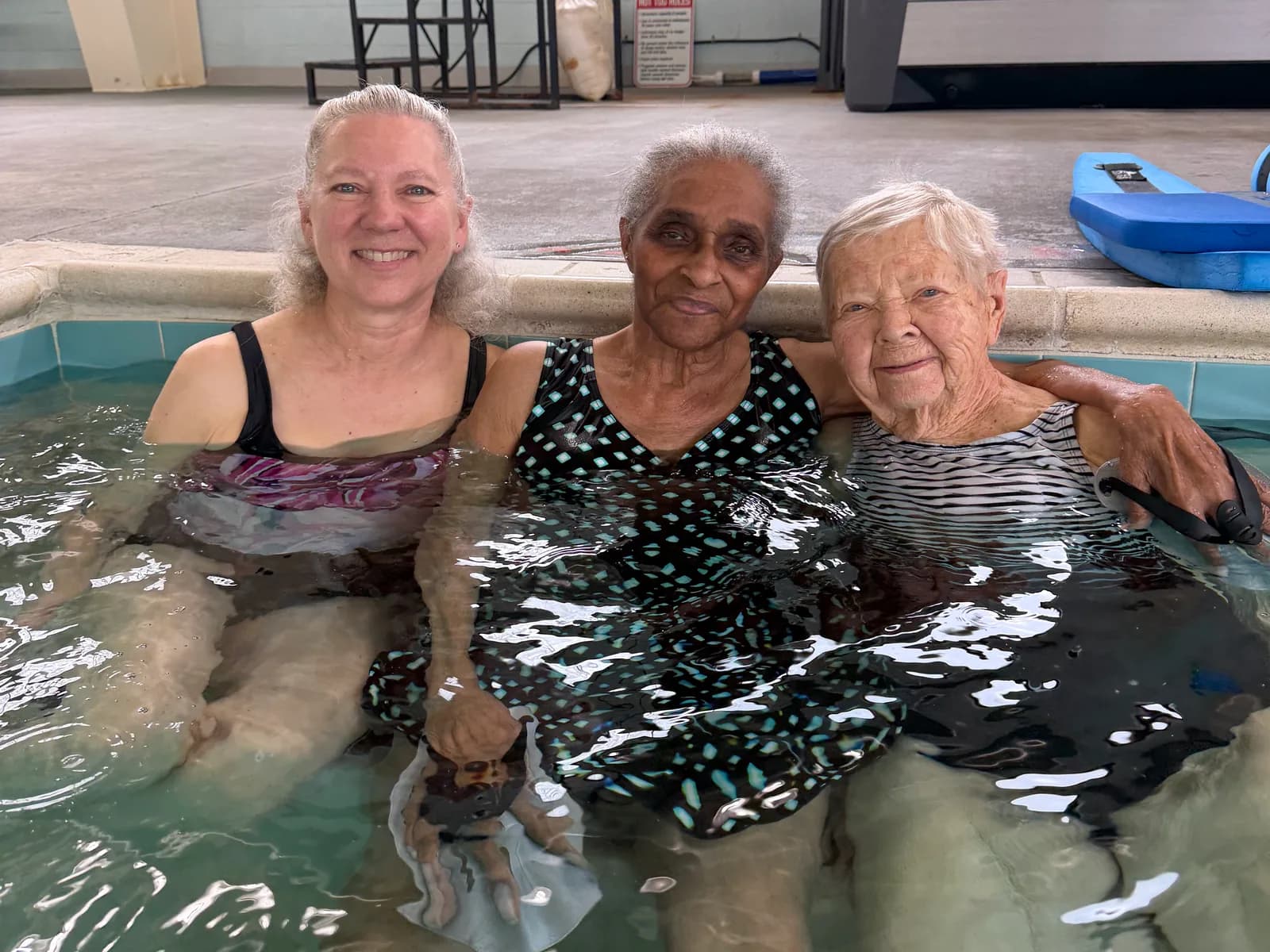 Three people together in the South Stafford therapy pool.