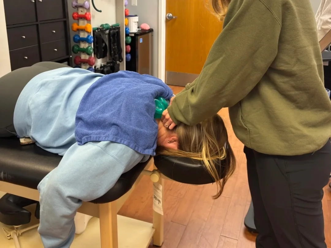 Cupping therapy applied to the upper back on a treatment table.