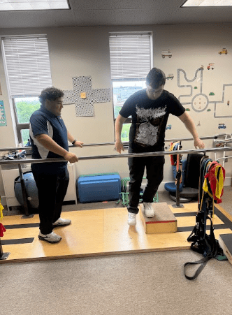Patient working with a provider at a physical therapy clinic in Reston, VA during a balance and vestibular rehabilitation exercise